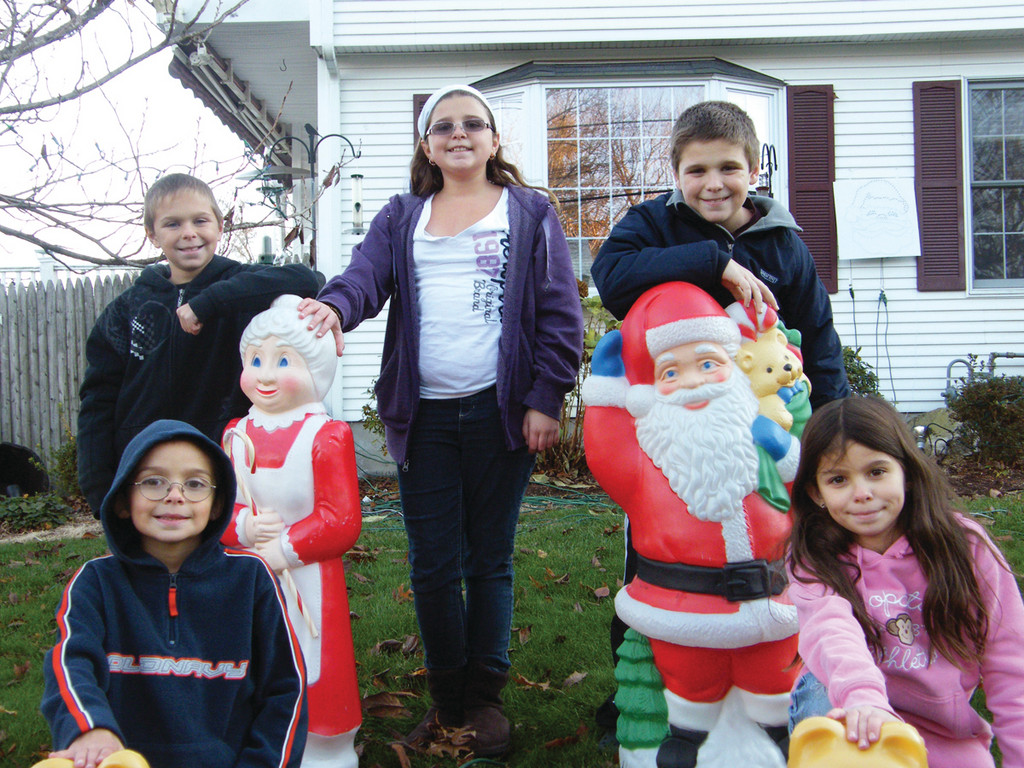 LEWIS FAMILY: The Lewis children enjoy decorating their home on Shenendoah, following in the footsteps of a decorating tradition their father started 15 years ago. Front row: Michael and Allie age 10. Back row from left: Michael, 9, Abby, 14 and Everett IV, 12.