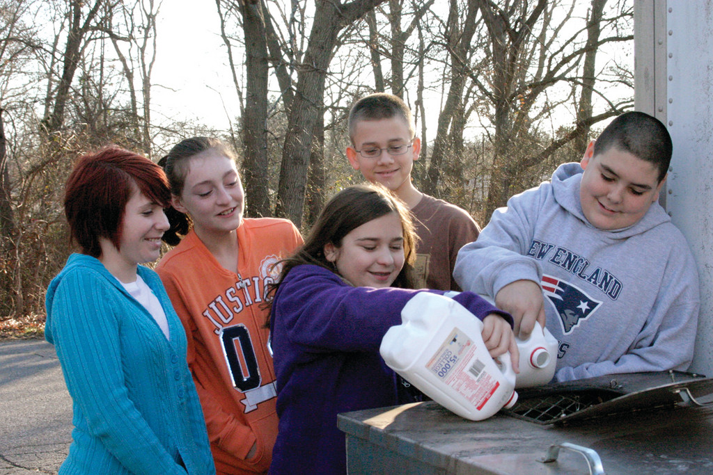 SLICK STUDENTS: Sixth graders at Sherman Elementary School are excited about the Turn Grease Into Fuel program, spearheaded by students at Westerly Middle School in 2008, and encourage people to donate used cooking oil so it can be diverted from the Warwick waste stream and converted into biodiesel fuel credits for needy families. From left, Alyssa Ferland, 12, Kalen Whitney, 11, and Matthew Fera, 12, look on as Nicole Racca, 11, and Kyle Denis, 12, drip the last few drops of oil into a receptacle located at their school.