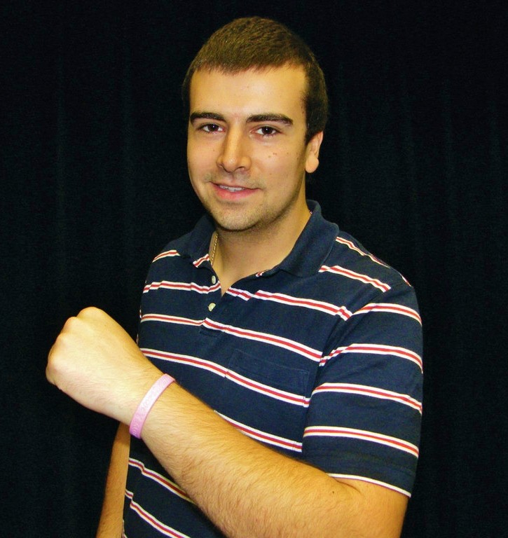 THINKING PINK: Michael Yanish, a Hendricken class of 2010 graduate, shows off his breast cancer wristband. Yanish addressed his fellow Hawks at an assembly yesterday, telling them about his experience with his mother, who was diagnosed with breast cancer when he was a sophomore.