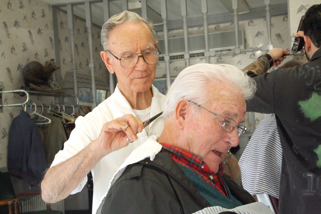 JUST A TRIM: Henry Lozier trims the hair of Paul Maggiacomo of Louie's Barber Shop, who hired him 51 years ago.