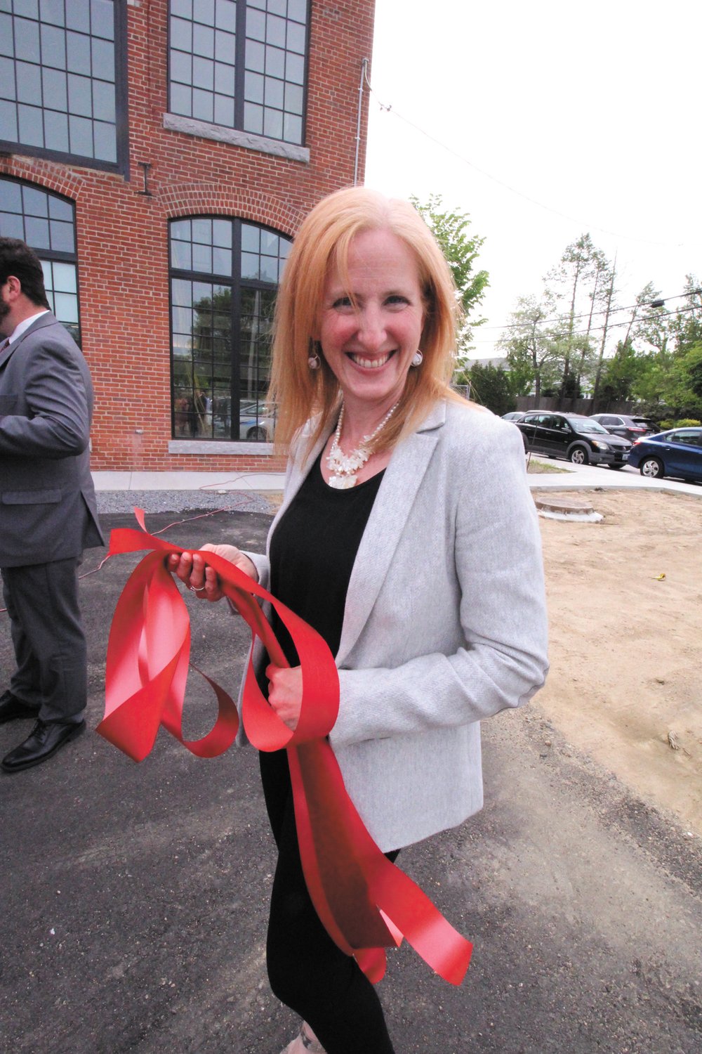 TIED UP AT WORK: Well, Shannon Reyes, manager of the Warwick AAA office was somewhat “tied up” Monday at the ceremonial opening of the offices at the Sawtooth Building in Apponaug. She oversees a staff of 18.