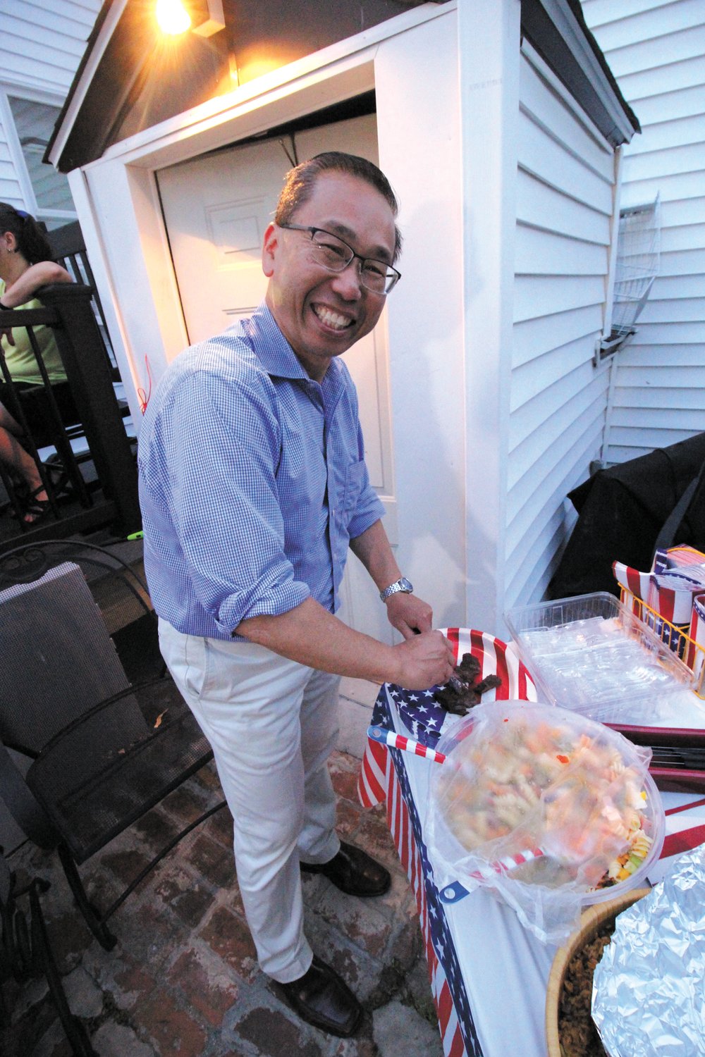 A WELCOME PAUSE: Former Cranston Mayor and CD2 Republican candidate Allan Fung took a break from campaigning Saturday to join the political barbecue. Before going on the airwaves he stopped to enjoy some freshly grilled steak