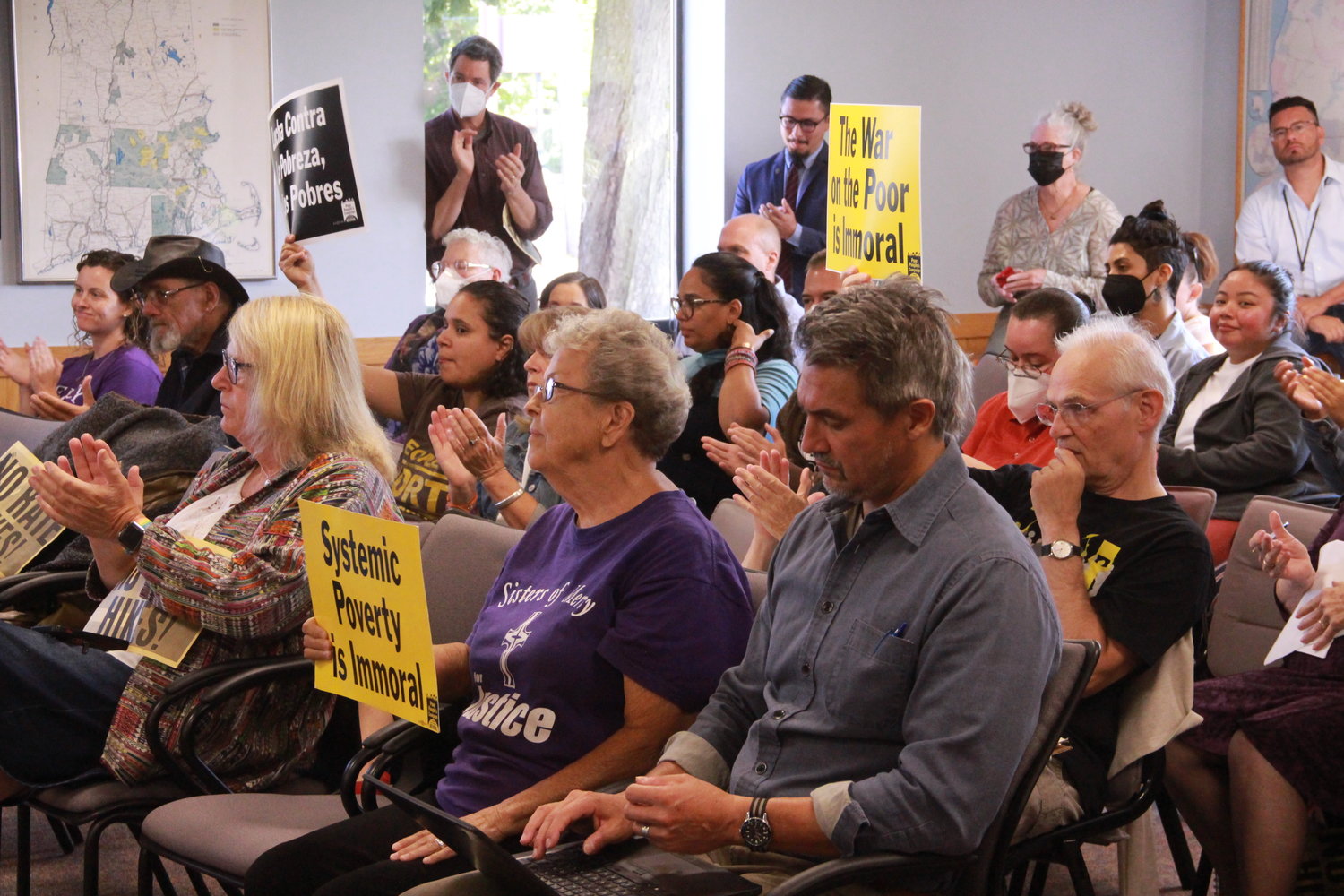 SIGNS OF 
PROTEST: Attendees at a public hearing on an increase in electricity rates held signs in protest. The hearing was held in Cranston before the state’s Division of Public Utilities and Carriers.