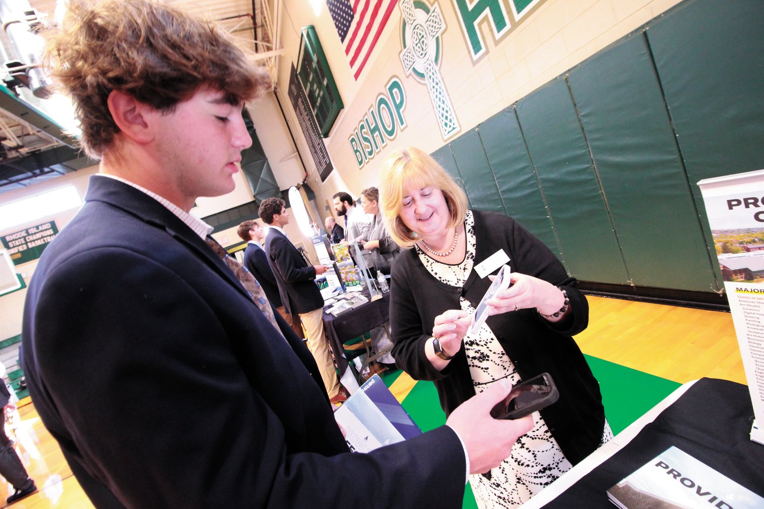 LESS FORMS, MORE TIME TO TALK: Nancy Eagan of Providence College traded information with students using her and their cell phones with the app StriveScan. The system allowed for college representatives and students to spend more time talking in place of completing forms.
