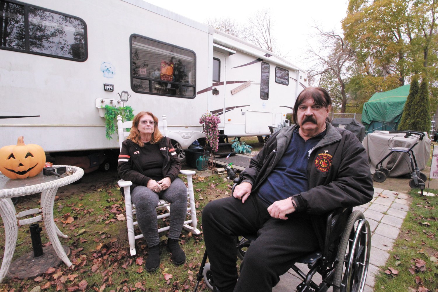 HOME AWAY FROM HOME:  Sharon Roy and Charles Scott outside the trailer on the Tidewater Drive property Scott owns in Warwick. Scott has been told he can stay in the trailer as long as he doesn’t go to sleep. (Warwick Beacon photos)