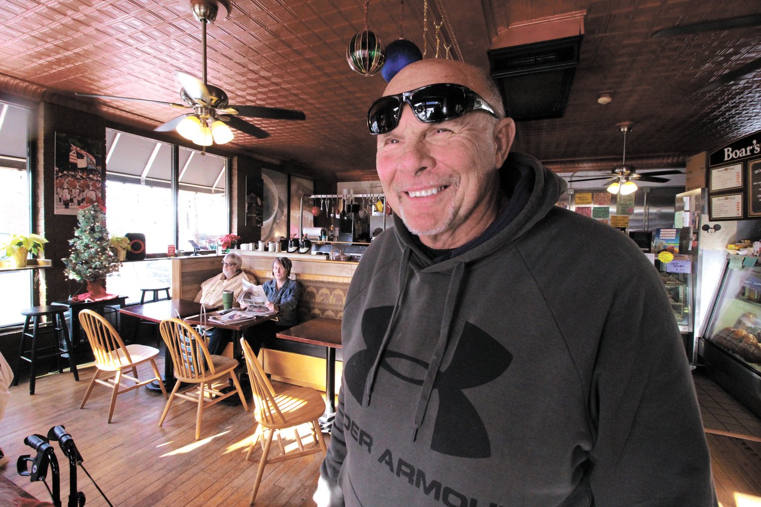 CHRISTMAS SPIRIT ABOUNDS: The business slows down but not the Christmas or village spirit says Ray Verrocchio of Bagel Express and Deli (below).