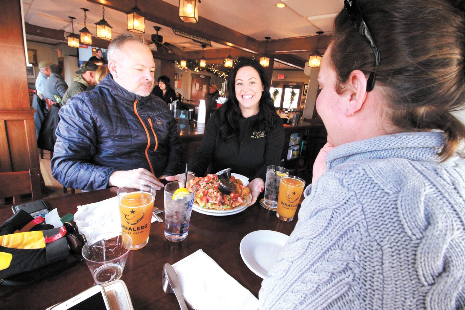LIKE FAMILY: Amy Chaffee serves Evan and Kristen Matthews their luncheon selection at O’Rourke’s Bar and Grill.