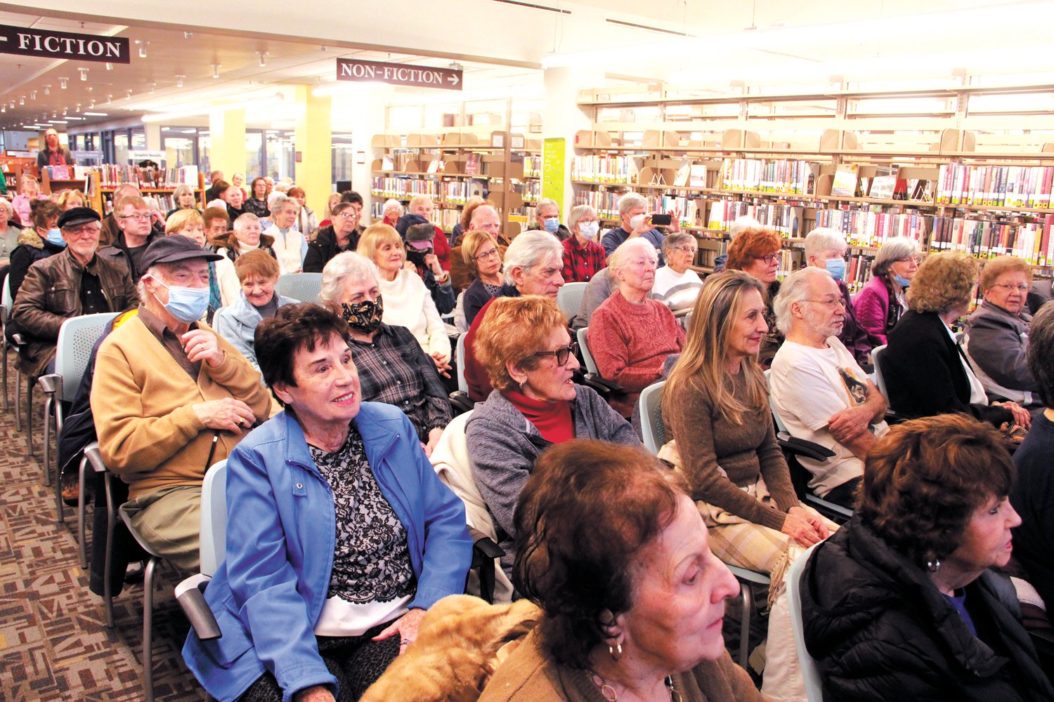PACKED BETWEEN THE AISLES: The library’s community room couldn’t accommodate the turnout, so concert goers booked on finding a seat among the shelves.