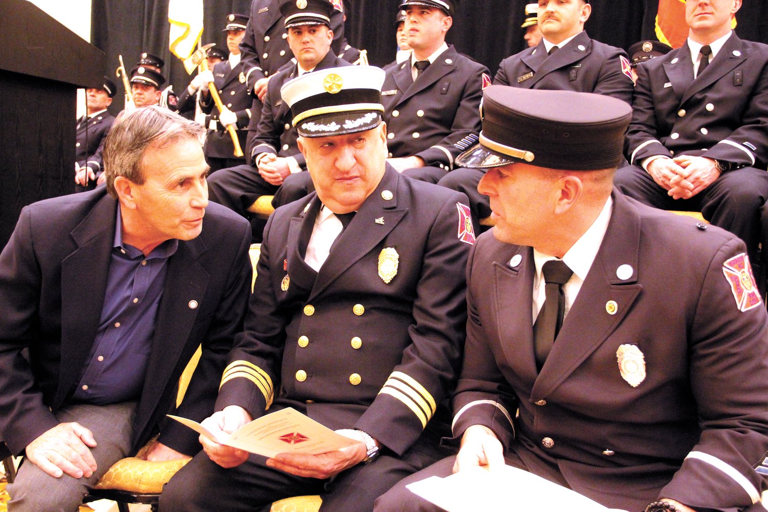 HOBNOBBING: Mayor Frank Picozzi, Father Robert Marciano and Lt. Michael Carriero confer before the commencement of ceremonies.