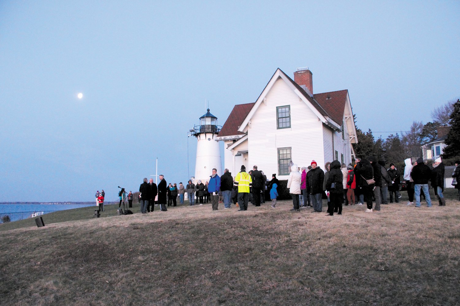 ONCE A YEAR: Easter Sunrise services have been a longtime tradition at Warwick Neck light. The service is one of the few occasions in recent times that the property is open to the public. This photo was taken this Easter as the moon was about the set and the sun rise. (Warwick Beacon photo)